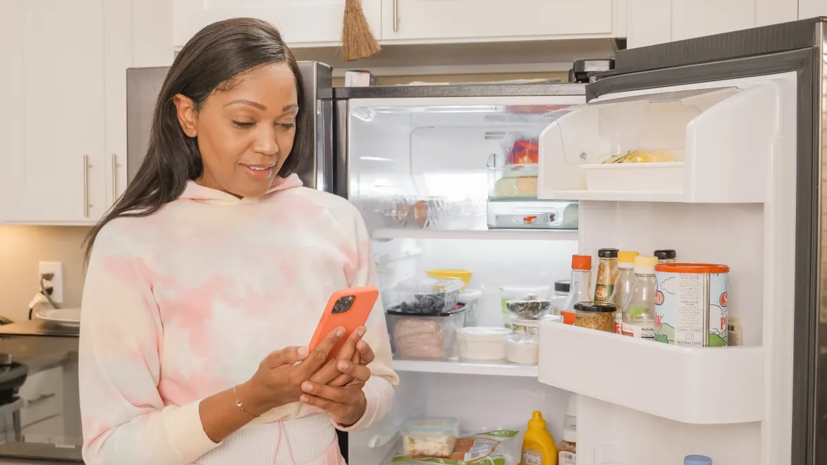 Checking the refrigerator interior label and care manual to confirm the specific exterior finish type.