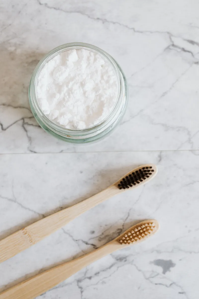 A gentle baking soda paste mixture used for safely removing stuck-on food splatters from surfaces.