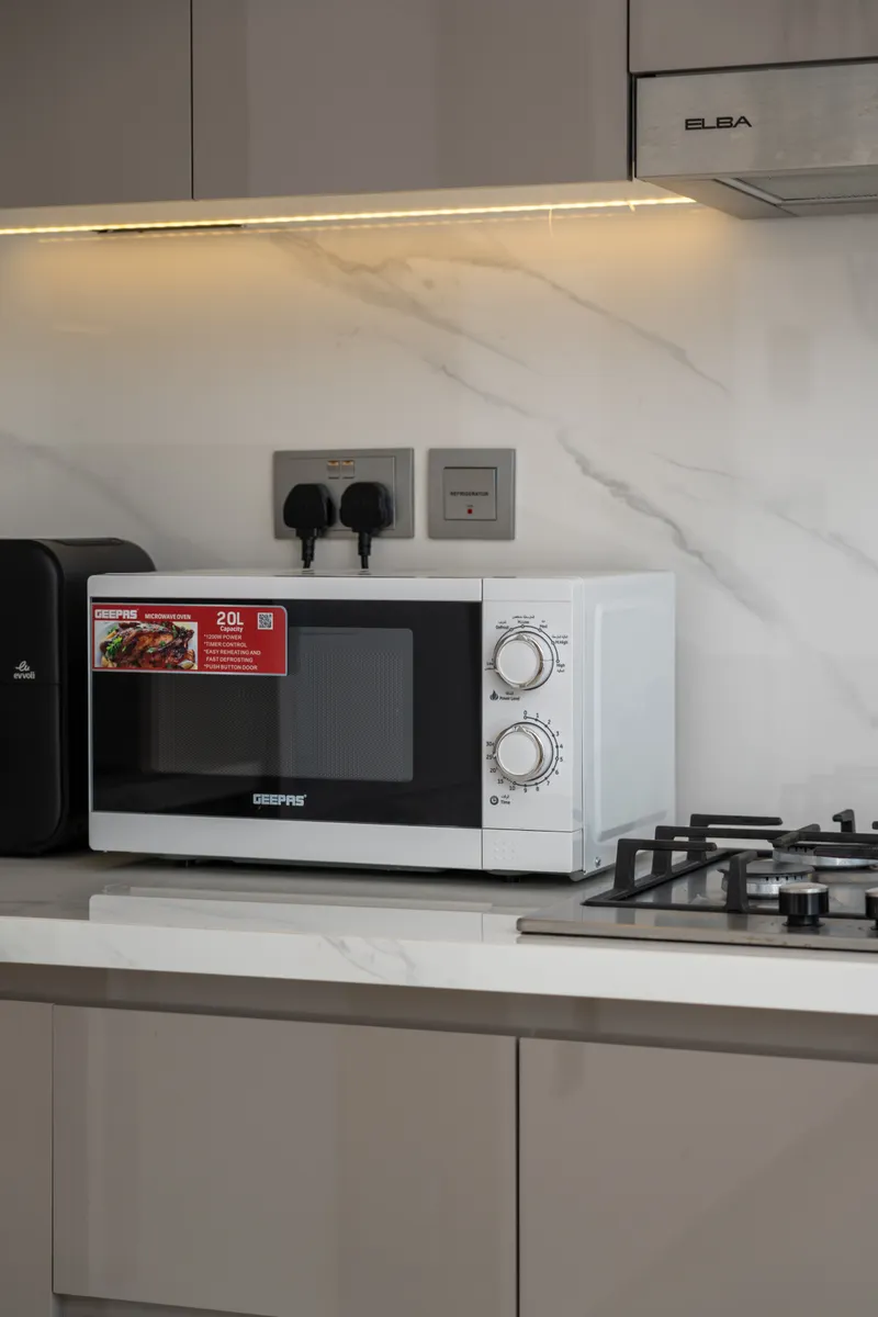 A gentle baking soda and water paste applied to a stubborn spot inside the microwave.