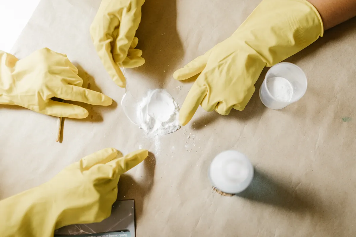 Applying a natural baking soda paste to a stubborn spot on the rubber seal.