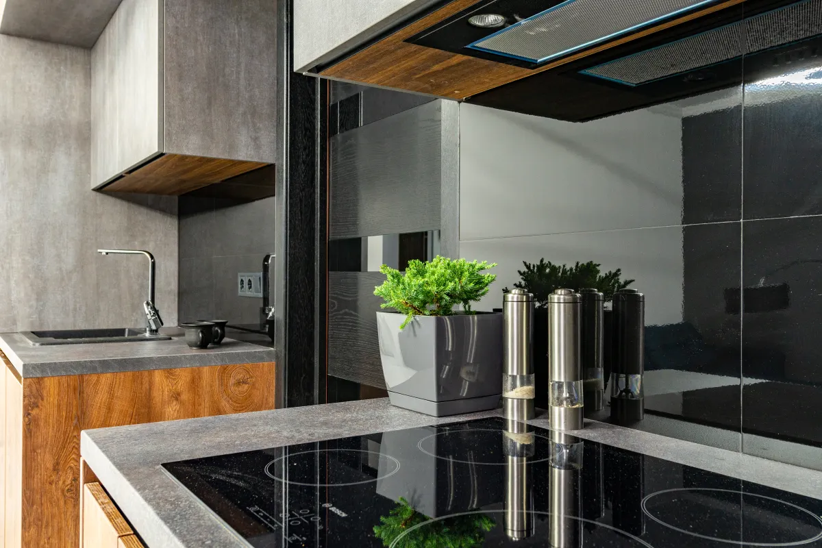 A clean glass cooktop and stainless steel kitchen appliances wiped down thoroughly.