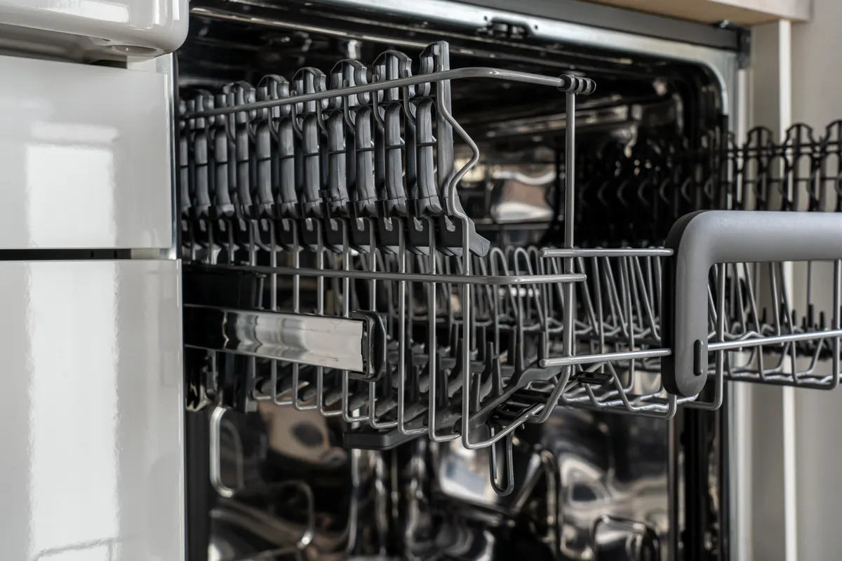 Close up of a dishwasher spray arm that requires quarterly deep cleaning checks.