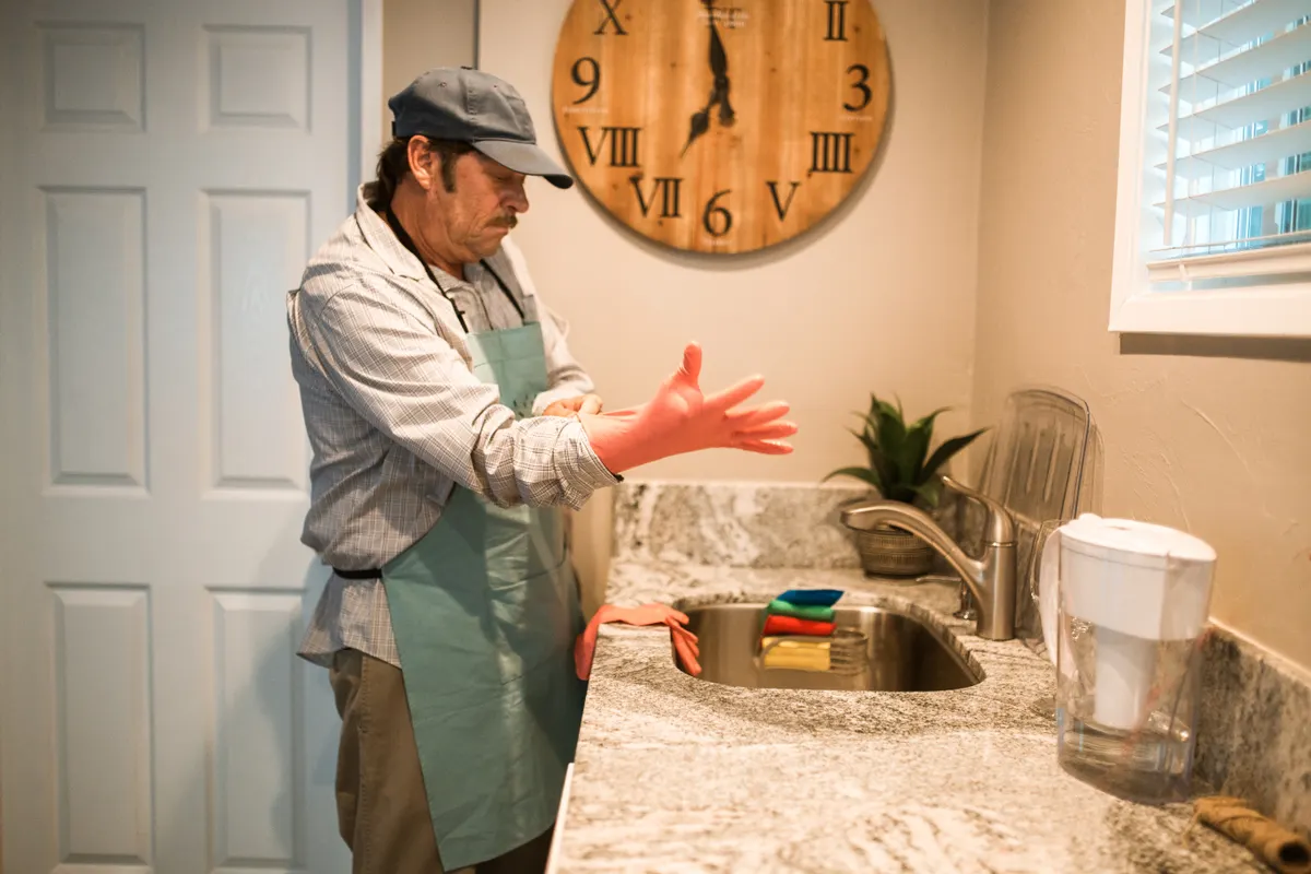 Rinsing a sealed concrete kitchen countertop thoroughly with clean water