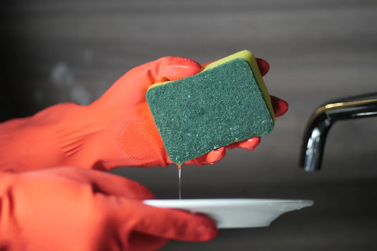 A close up of premium and budget kitchen cleaning tools used for heavy duty grease removal.