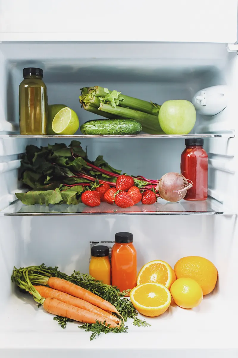 Fresh vegetables stored neatly in a clean refrigerator drawer during routine maintenance.