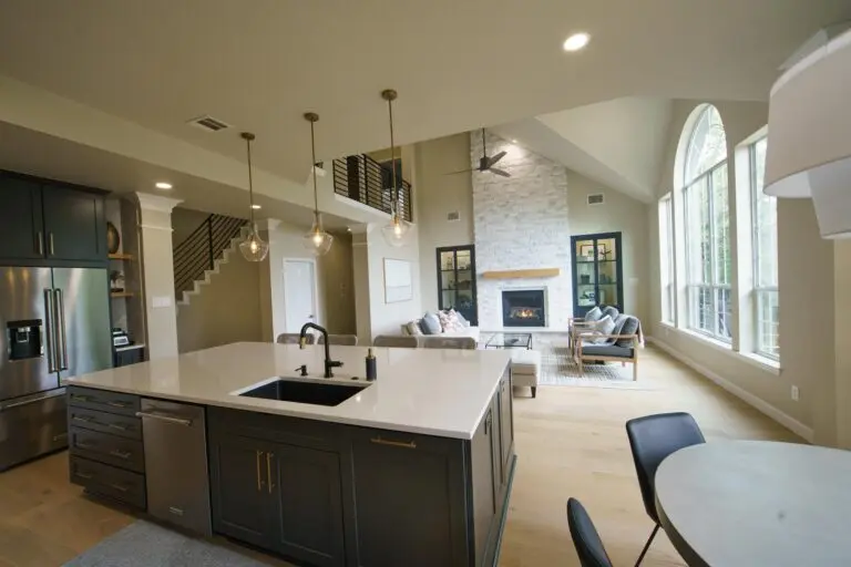 A kitchen countertop showing granite and engineered quartz surfaces compared side by side.