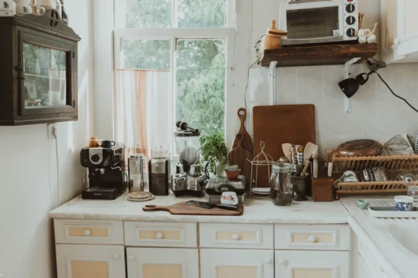 A clean modern kitchen counter and appliances prepared for a deep cleaning session.
