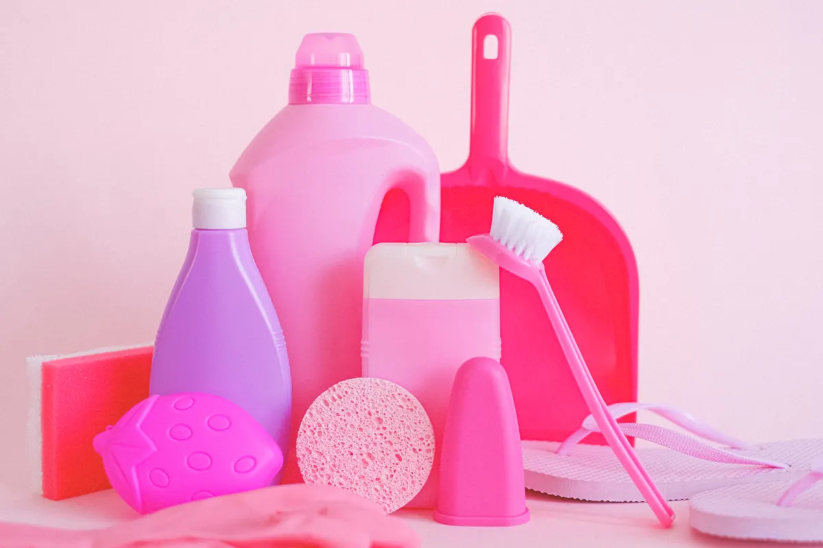 Various common kitchen cleaning supplies like soap, vinegar, and a soft sponge.