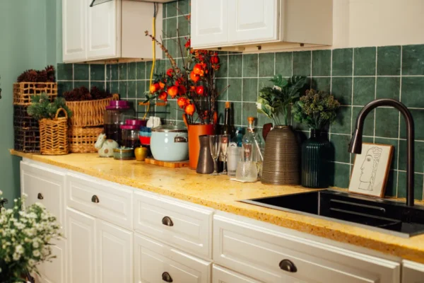 A clean modern kitchen counter with cleaning supplies ready for routine maintenance.