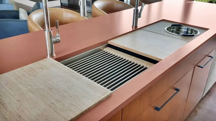 Wood butcher block and stainless steel kitchen countertops next to laminate