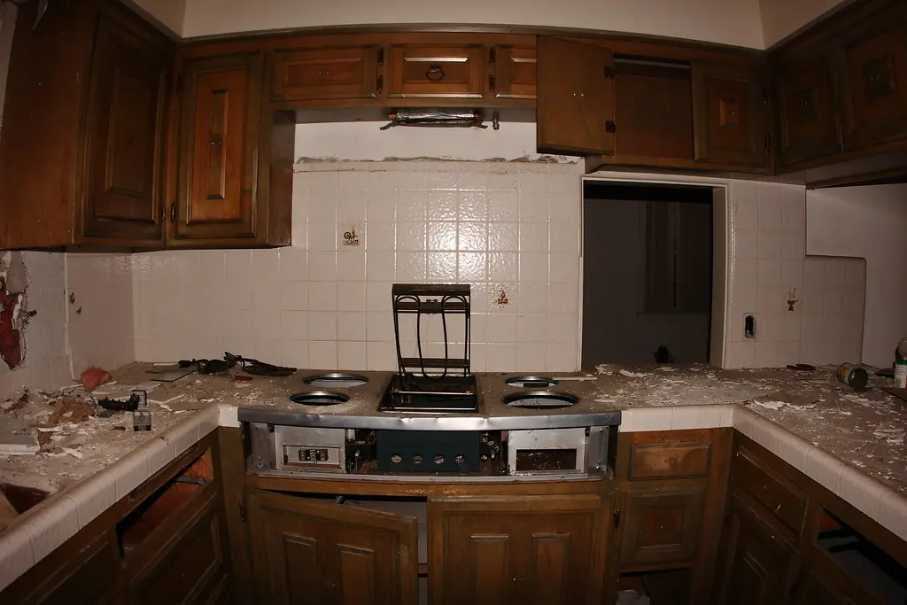 A damaged kitchen countertop surface requiring professional specialist attention after harsh chemical wear.