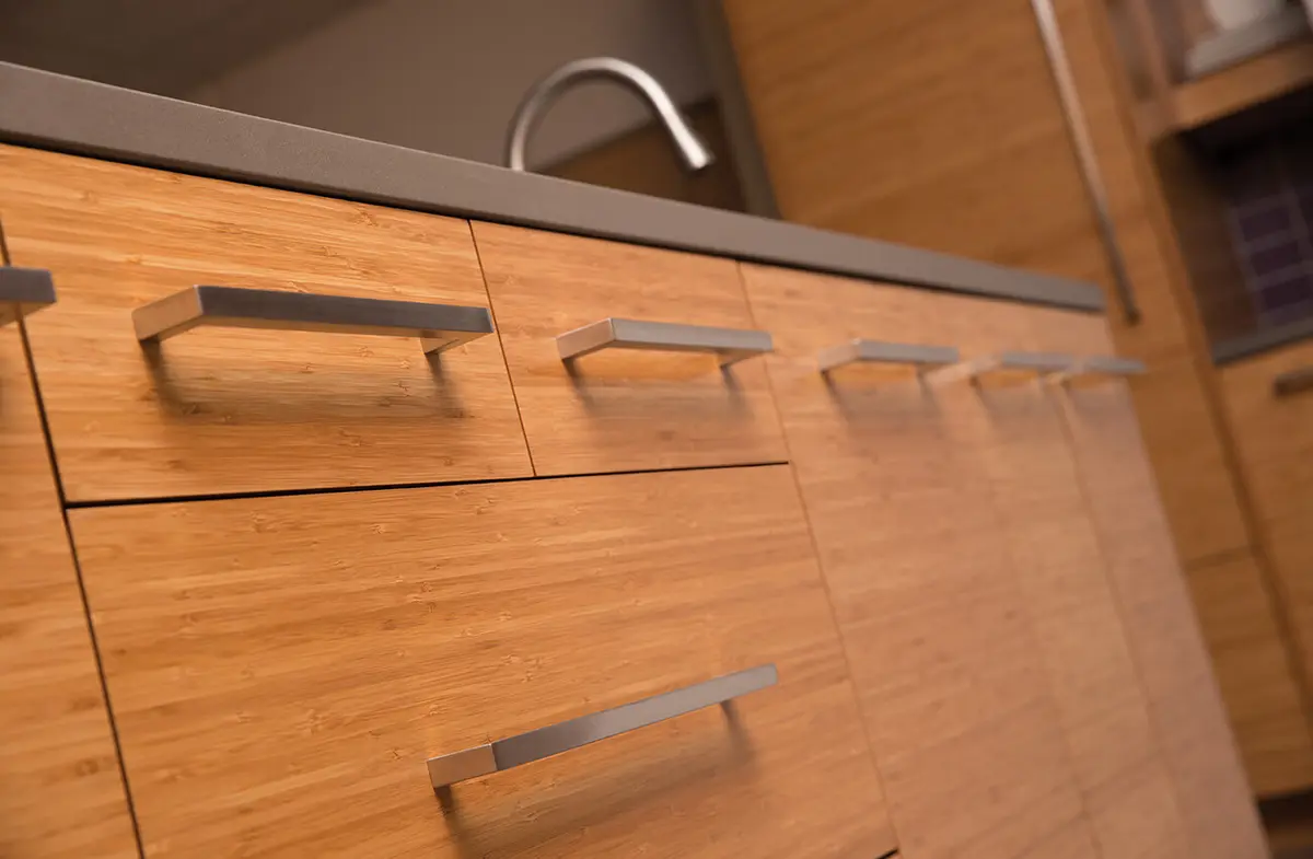 Close up of wooden kitchen drawers and cabinet surfaces requiring careful material matching