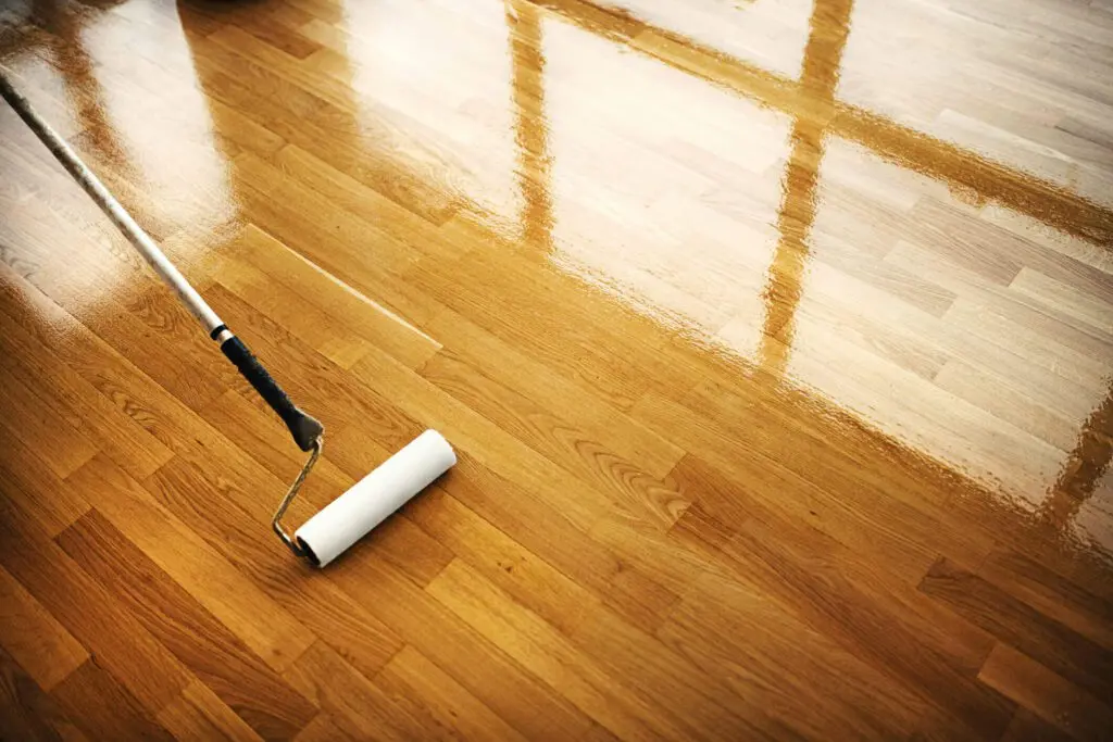 Kitchen hardwood flooring showing potential water damage and swelling at seams.