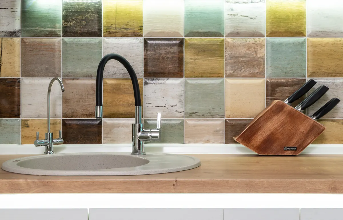 An unsealed wood surface and a kitchen countertop showing material compatibility differences.