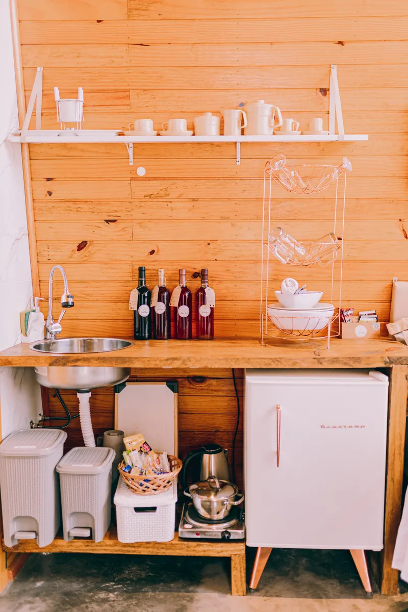 Neatly arranged bottles of kitchen cleaning products stored efficiently under a sink.
