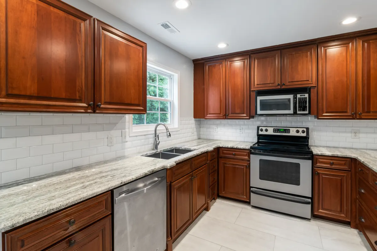 Detailed view of kitchen grout lines and appliance handles often missed during routine cleaning.