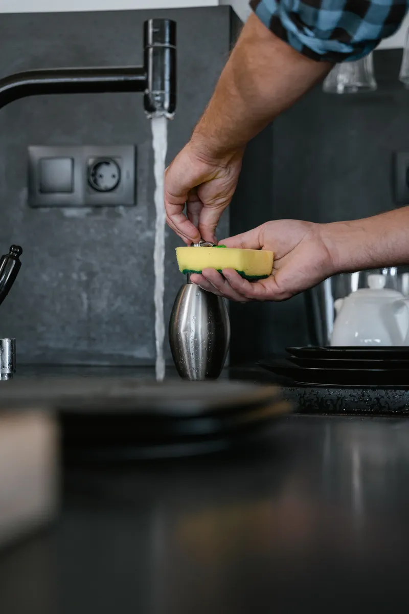 A clean kitchen sponge sitting in a caddy to dry properly between daily use.