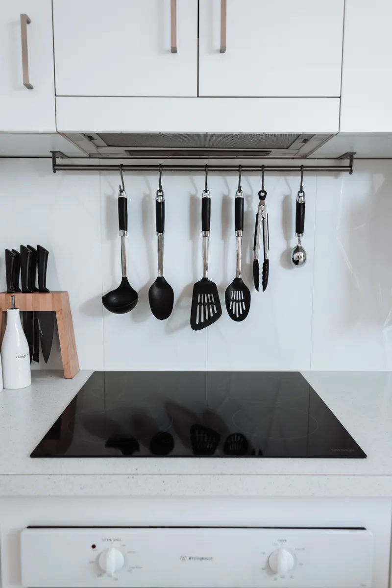 A clean modern kitchen with major appliances arranged neatly along the counter and cabinetry.