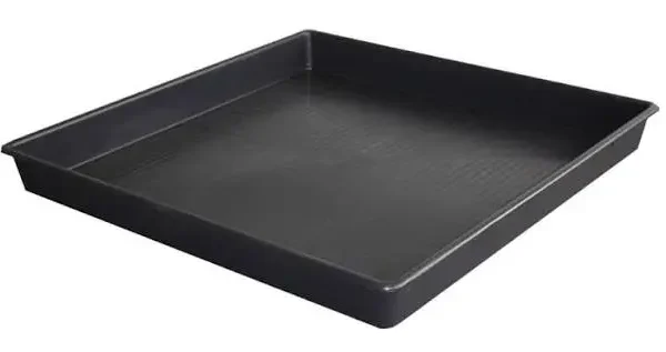 Close-up of a refrigerator drip pan being cleaned with a sponge and soap.