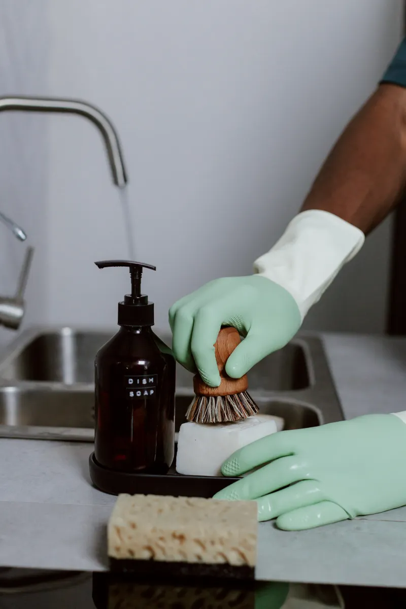 Practical cleaning supplies including microfiber cloths, dish soap, and baking soda for renters.