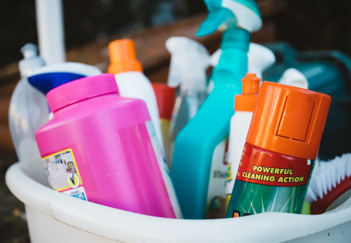 A selection of safe cleaning tools including microfiber cloths and pH neutral stone cleaners for natural granite.