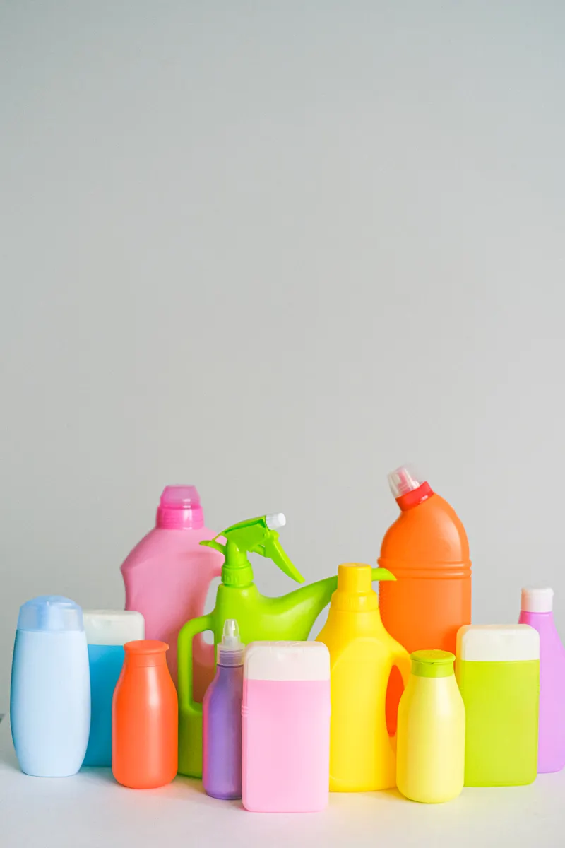 Various safe household cleaning supplies arranged neatly on a surface for kitchen disinfecting and sanitizing.