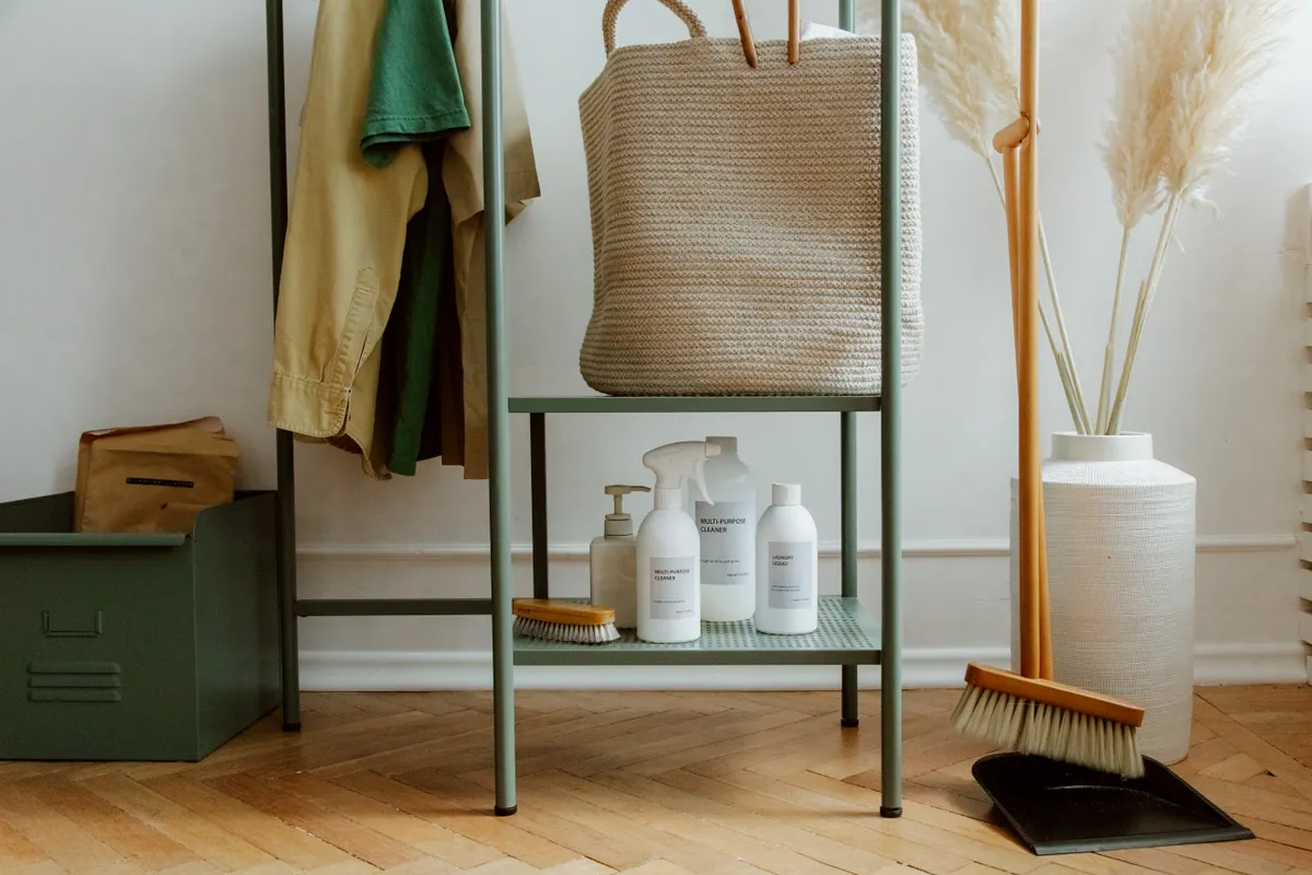 Assorted safe cleaning products and specialty solutions organized neatly for kitchen floor maintenance.