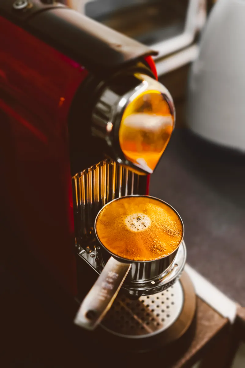 A modern single-serve pod coffee machine requiring specialized internal descaling care.