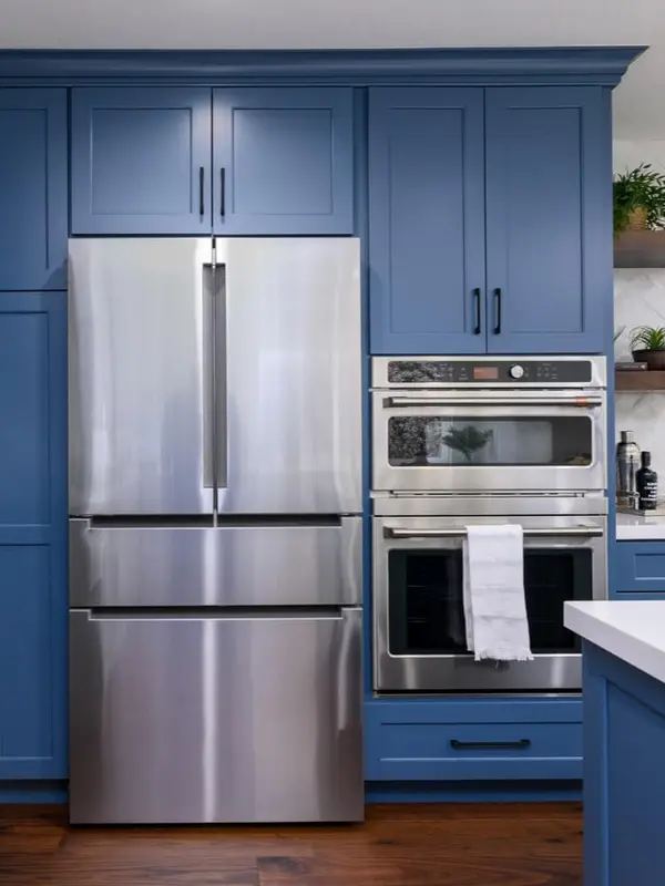 Wiping a stainless steel refrigerator exterior in the direction of the grain with a soft cloth.