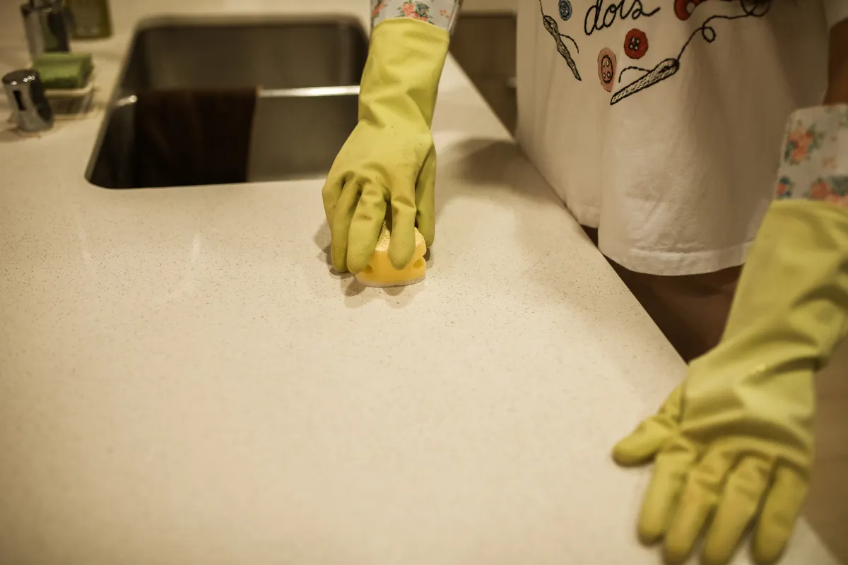 A close up view highlighting surface contact time guidelines on a detailed kitchen cleaning dilution reference sheet.