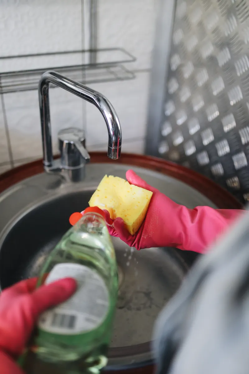 Applying a gentle cleaning paste to a small section of a concrete countertop