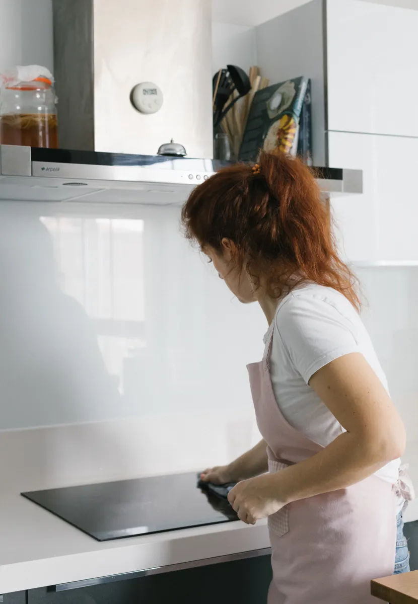 Testing disinfectant spray on a corner of a granite kitchen countertop surface safely