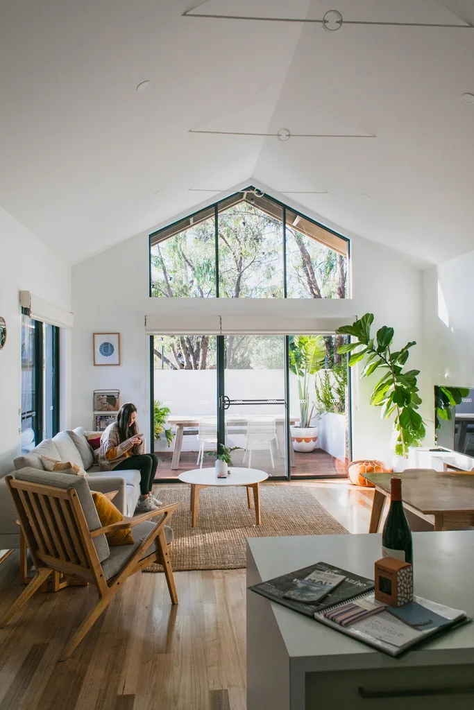 Bright, tidy living room with a neatly made sofa