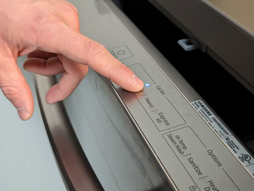 Wiping down the dishwasher control panel and door seal carefully with a damp cloth.